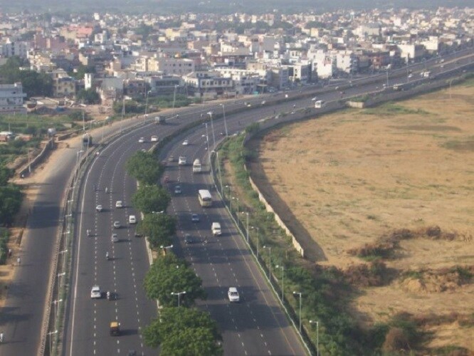 Noida extension_a city street filled with lots of traffic